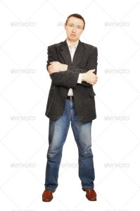 Man in a jacket and dark blue jeans crossed his hands on a breast